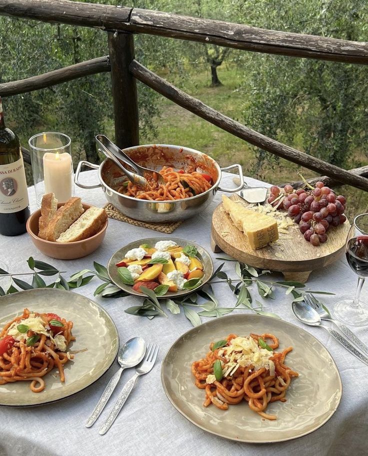 a table topped with plates of food and wine