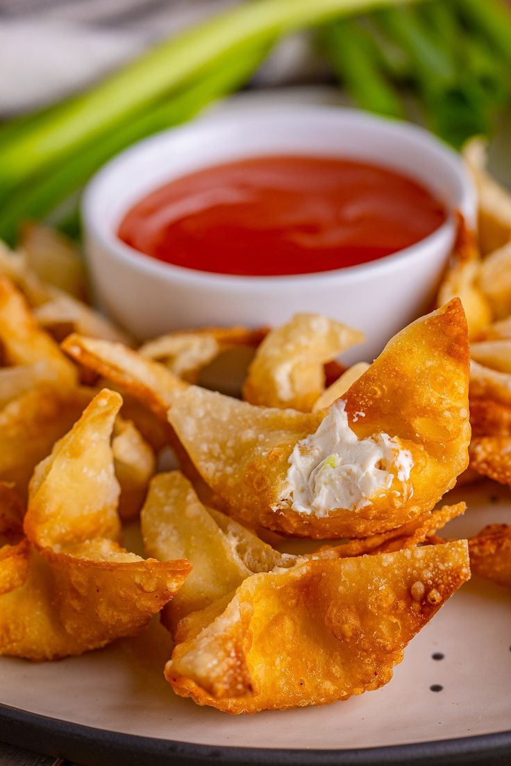 some fried food on a plate with dipping sauce