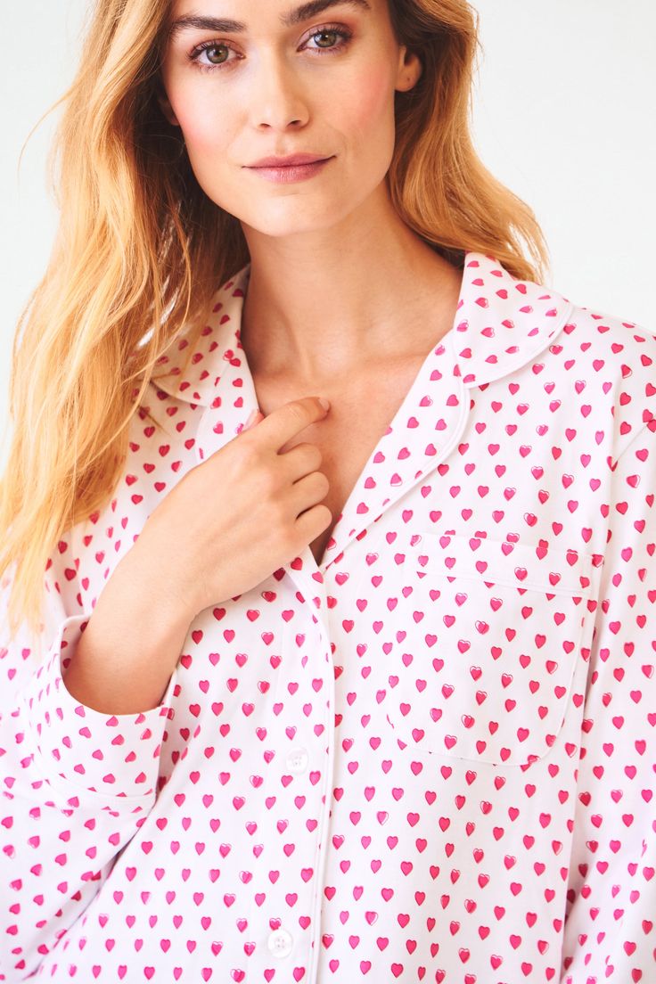 You sleep better in cute pajamas — it's science. The Perlita Lounge Dress is a super soft cotton nightshirt with a button front and front pocket. The pink heart print adds a fanciful touch to a classic sleep style. Button Front Closure Functional Breast Pocket Piping Detail Materials and Care 100% Long-Staple Premium Cotton Machine Wash Cold, With Like Colors Do Not Bleach, Tumble Dry Low (Line Dry Recommended) Imported Measurement Information Model Wears Size Small Size S Length: 34.5" (from Sh Pink Summer Tops For Overnight, Spring Sleepwear With Pockets, Relaxed Fit Sleepwear With Pockets For Bedtime, Casual Heart Print Tops For Pajama Party, Pink Relaxed Fit Sleepwear For Sleepover, Spring Cotton Sleepwear For Overnight Use, White Sleepwear With Pockets For Sleepover, Spring Sleepwear With Pockets For Bedtime, Cute Relaxed Fit Sleepwear