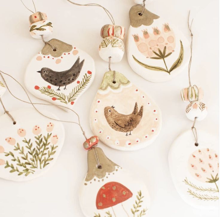 ceramic ornaments with birds and flowers painted on them