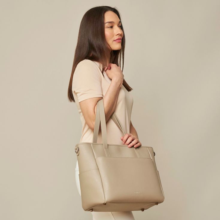 This structured tote is the ultimate do-it-all bag that you deserve. It's the perfect carryall for work, travel, and anywhere your day brings you. It features a spacious and organized interior for your essentials, a padded compartment for your laptop, side pockets for your drinks, and you can convert it into a backpack or crossbody. Crafted from premium American Saffiano leather that's waterproof and scratch-resistant, the Transform Tote will stay just as beautiful through all your travels and a Modern Weekender Bag With Removable Pouch For On-the-go, On-the-go Tote Bag With Laptop Sleeve, Modern Tote Briefcase For Travel, Modern Briefcase Tote For Travel, Modern Tote Satchel With Luggage Sleeve, Modern Satchel Laptop Bag For On-the-go, Modern Travel Satchel Tote, Versatile Business Weekender Tote Bag, Modern Travel Tote Satchel