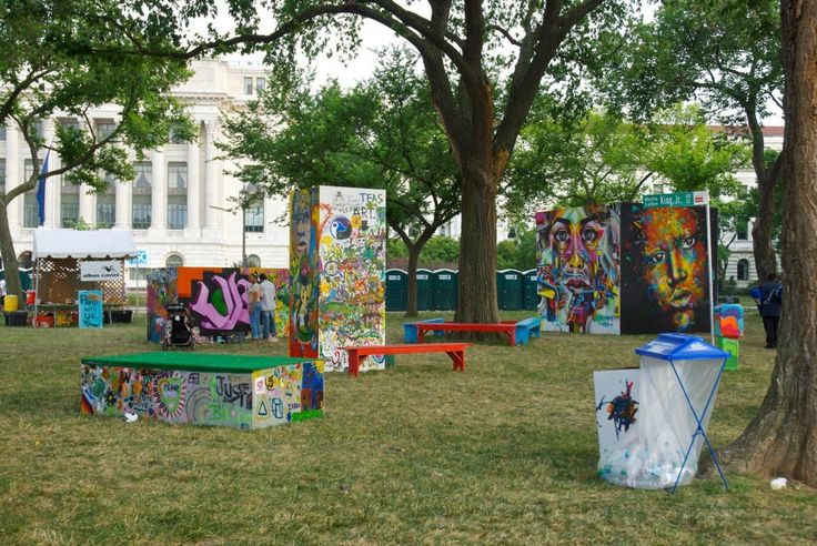 several colorfully painted benches and tables in the park