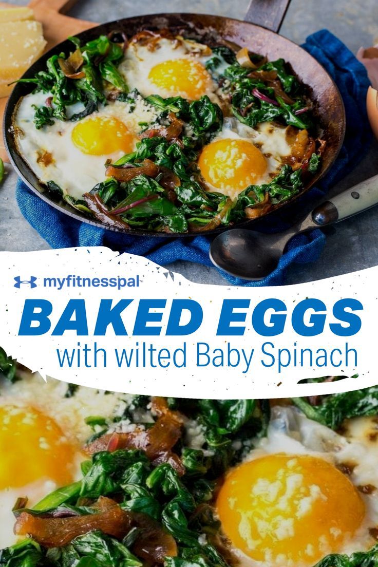 baked eggs with wilted baby spinach in a skillet