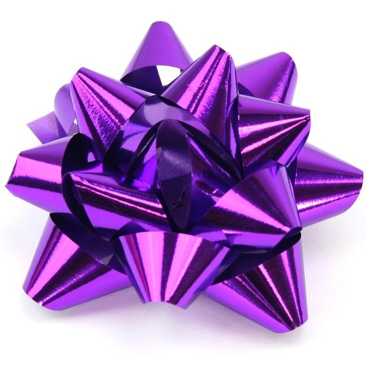 a purple bow that is on top of a white surface and has many smaller bows attached to it