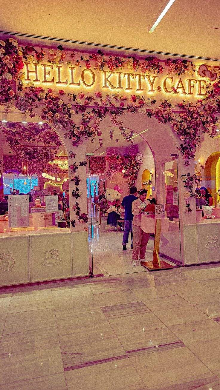 the entrance to hello kitty cafe at night