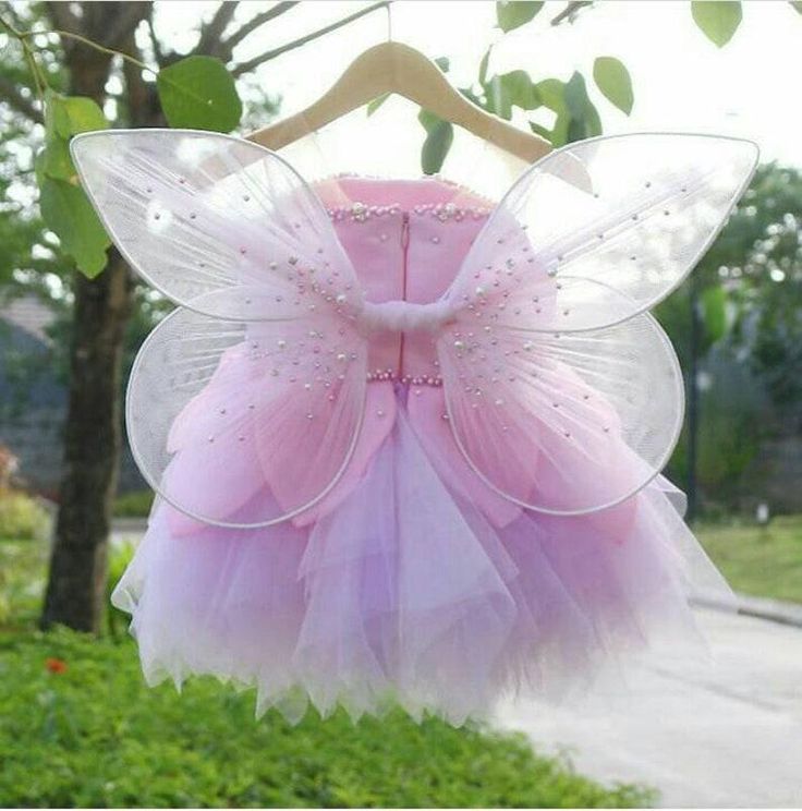 a pink fairy dress hanging from a tree