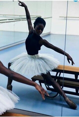 two ballerinas in white tutu and black leotards