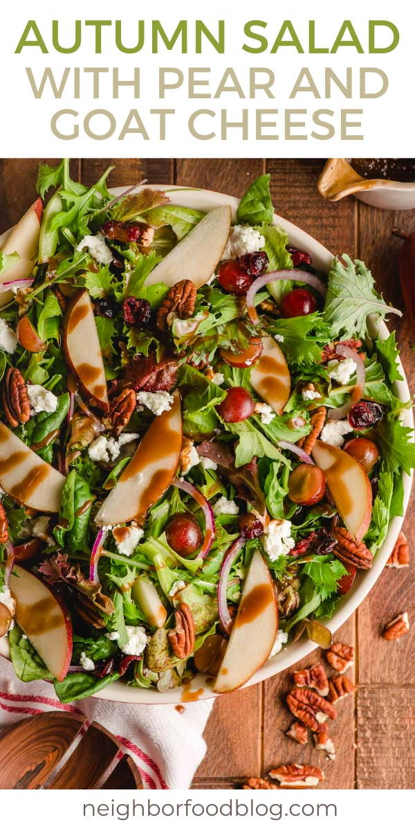 an apple salad with pears and goat cheese in a white bowl on a wooden table