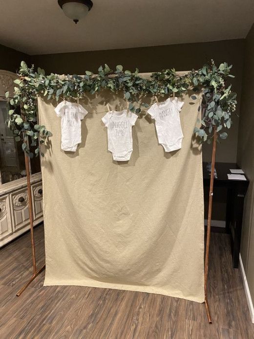 two baby ones are hanging on the clothesline in front of a dresser and mirror