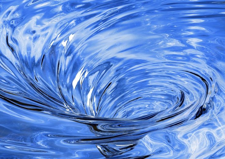 blue water swirls in the air and creates a circular pattern on it's surface