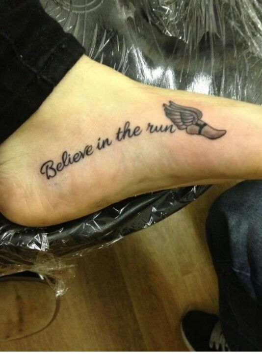 a person with a tattoo on their foot that says, believe in the run