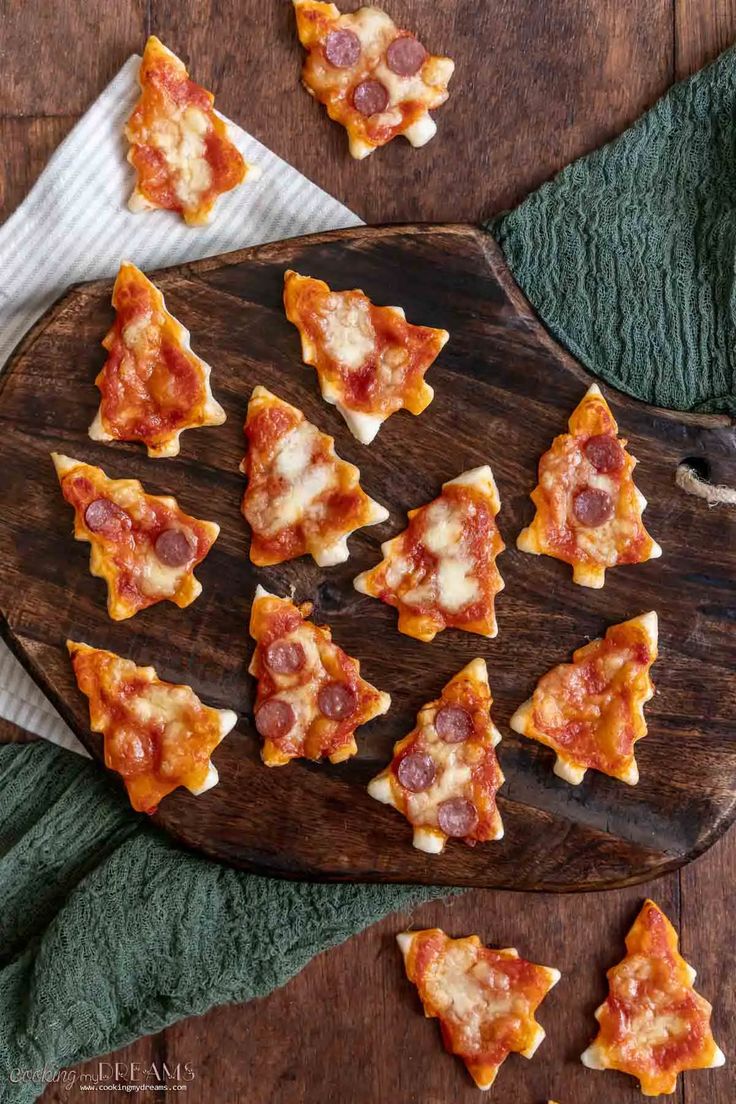 small slices of pizza on a wooden cutting board