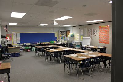 an empty classroom with desks and chairs