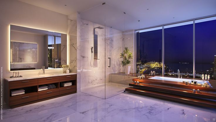 a bathroom with a tub, sink and large window overlooking the city lights at night