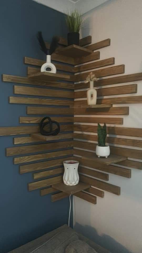 a wall mounted shelf with some plants on it and other items in the corner next to it