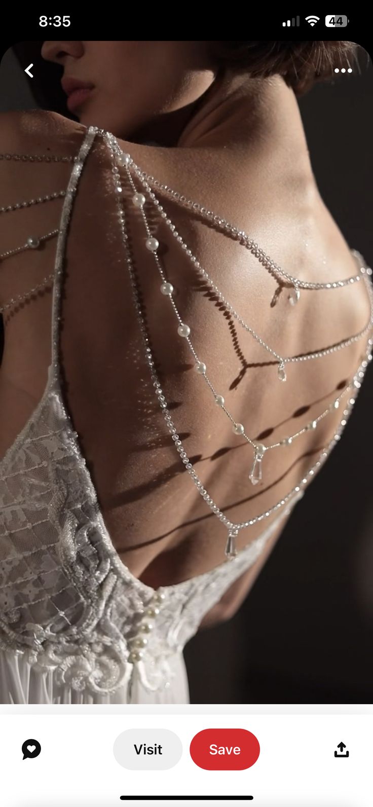 the back of a woman's dress with beads on it