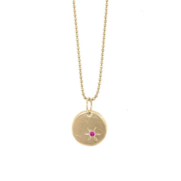 The 14k gold HAMY charm is a baby round pendant with a brushed satin finish featuring a single pink sapphire with hand etching. A perfect piece to wear daily for a simple elegance, or to layer with other charms. Available as pendant only, or with our recommended chain. Make it custom with the gemstone color of your choice. Additional chain options available in our Chains & Chokers collection. Complimentary engraving on back - ideal for "2022" or initials. Chain shown is 14k gold 1.0 mm diamond c Yellow Gold Round Birthstone Jewelry, Yellow Gold Birthstone Jewelry Round Shape, Gold Jewelry With Pink Sapphire, Yellow Gold Pink Sapphire Fine Jewelry, Fine Jewelry In Yellow Gold With Pink Sapphire, Pink 14k Gold Jewelry With Charms, 14k Gold Round Birthstone Jewelry, 14k Gold Medallion With Birthstone, 14k Gold Medallion With Birthstone Jewelry