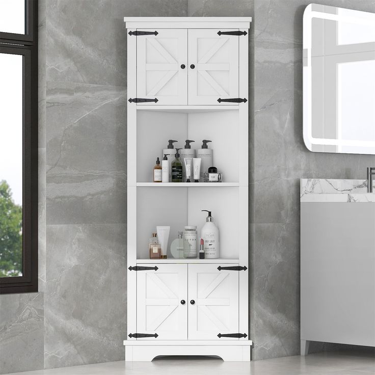 a bathroom with a white cabinet next to a sink and mirror on the wall in front of it