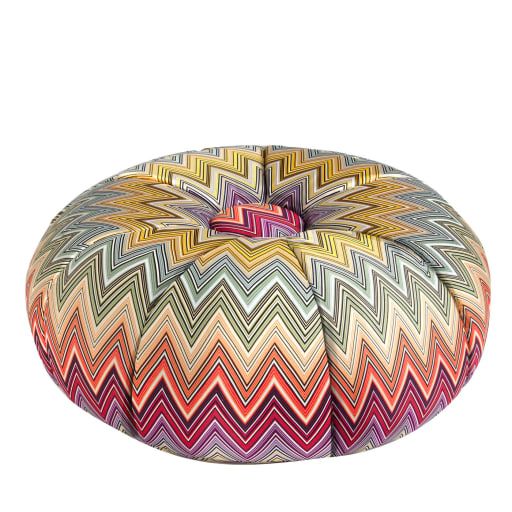 a multicolored round poufle on a white background