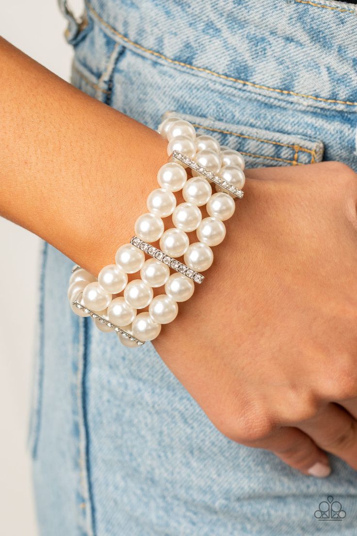 Held together by white rhinestone dotted silver fittings, row after row of bubbly white pearls are threaded along stretchy bands around the wrist for a timeless elegance.

 Sold as one individual bracelet. White Pearl Bracelet, Beads Bracelet Design, White Bracelets, Paparazzi Accessories, White Rhinestone, Stretchy Bracelets, Paparazzi Jewelry, Jewelry Business, Boutique Jewelry