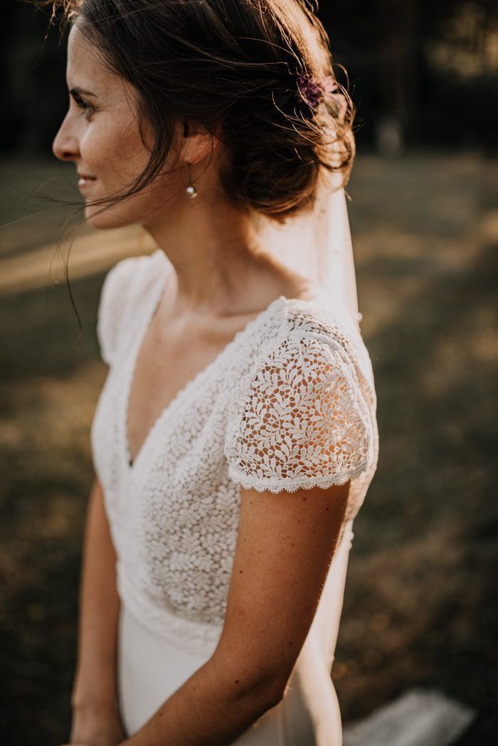 a woman wearing a wedding dress in the woods