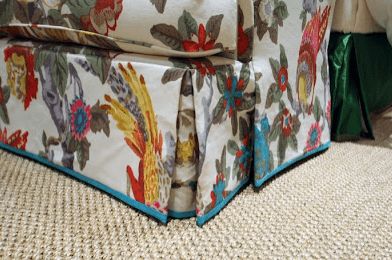 a close up of a flowered couch on the floor