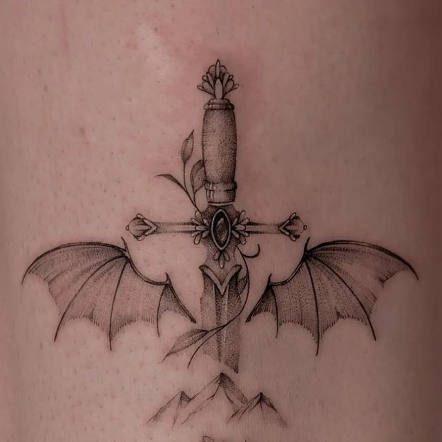 a cross tattoo with a dragon on it