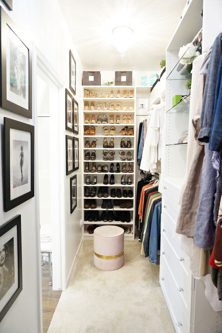 a walk in closet filled with lots of shoes and pictures on the wall next to it