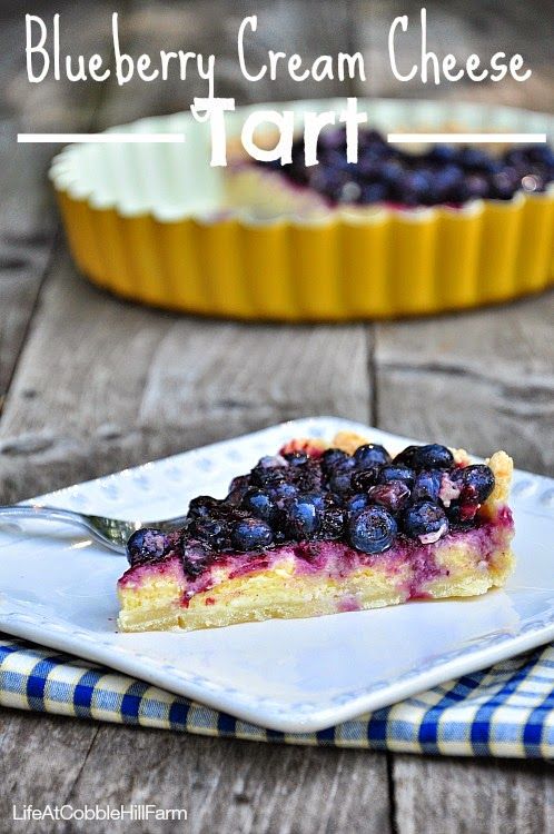 blueberry cream cheese tart on a white plate with a fork in front of it