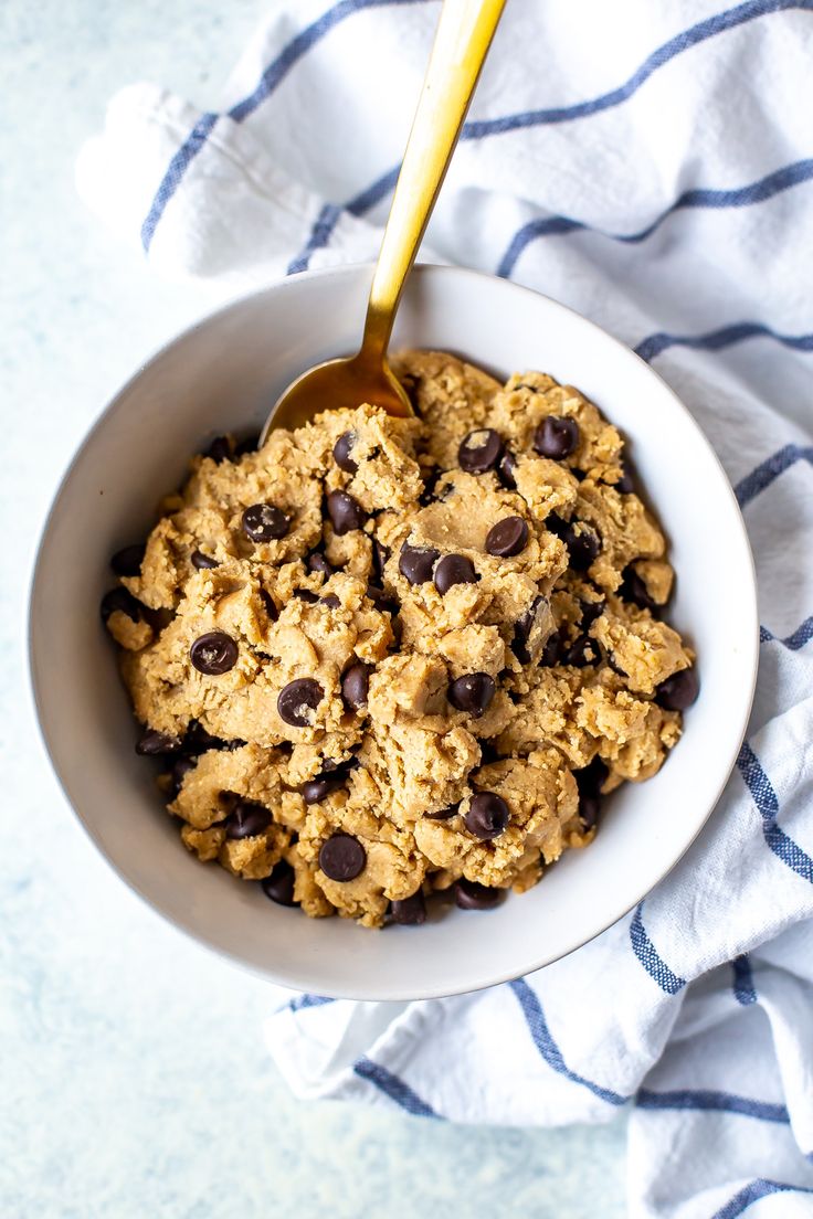 a bowl filled with oatmeal and chocolate chips on top of a towel