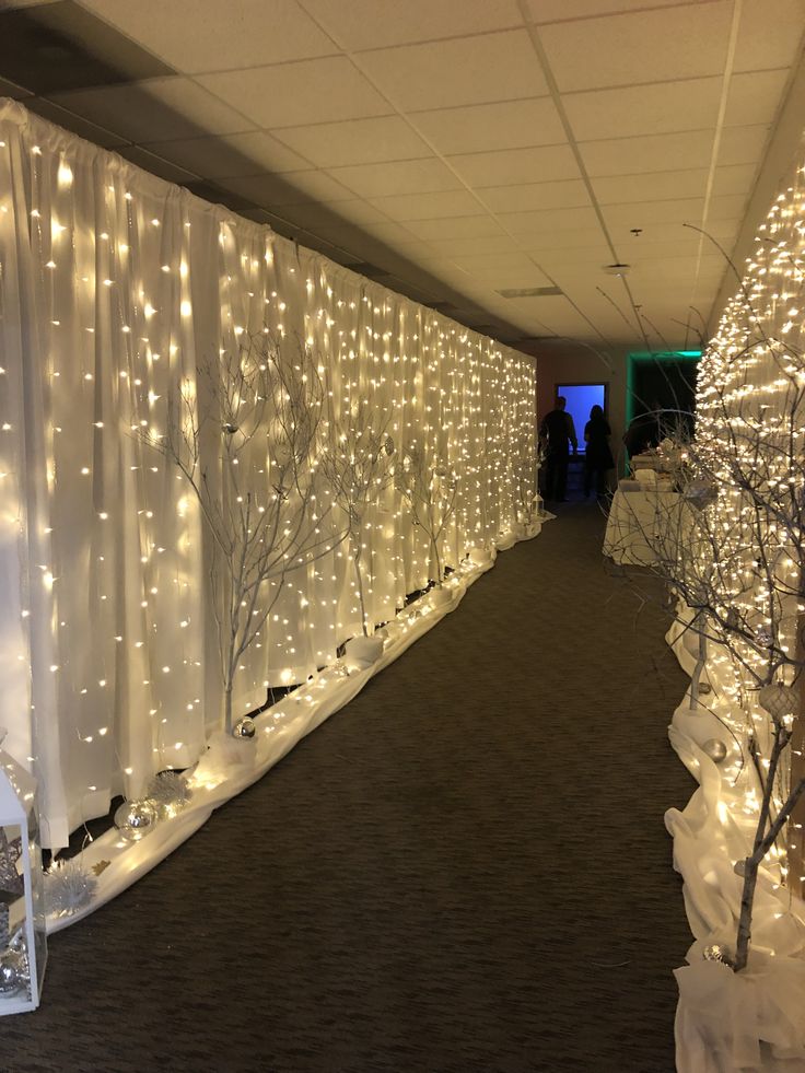 the hallway is decorated with white lights and trees