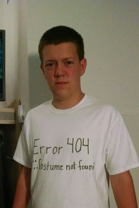 a young man standing in front of a tv with the words error 404 written on it