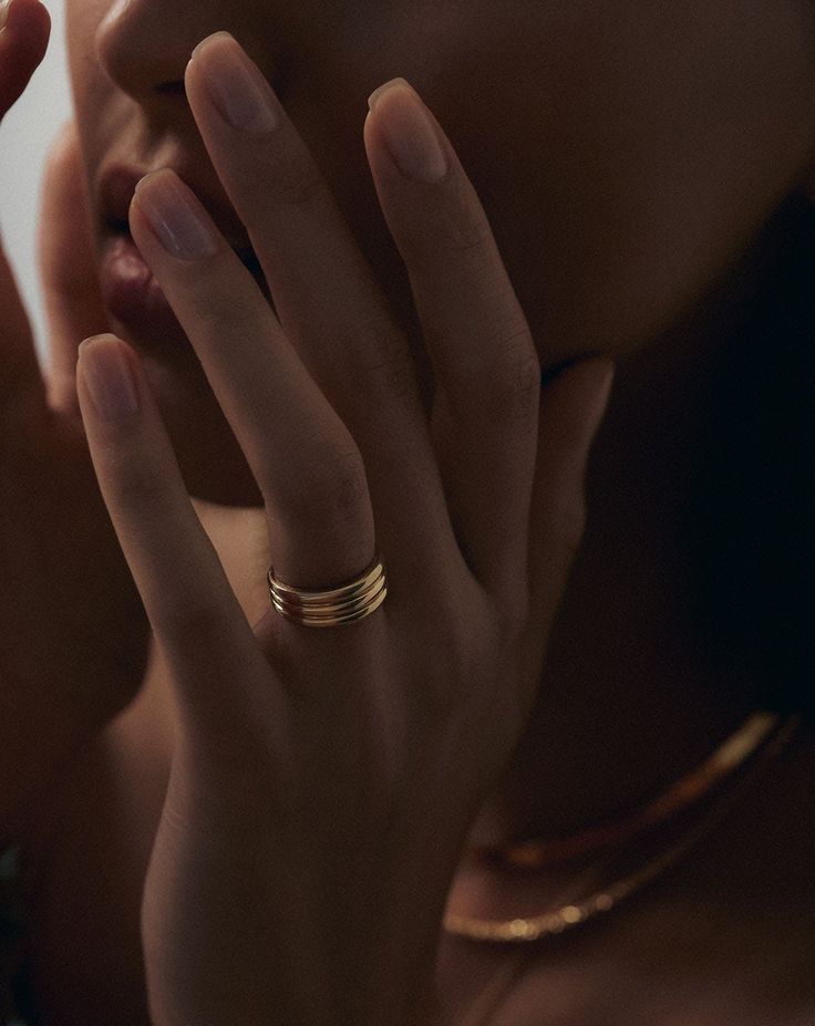 a close up of a person holding their hand to her face with both hands and fingers