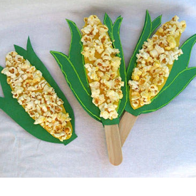 three corn on the cob sticks with toppings