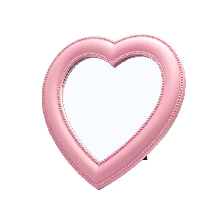 a pink heart shaped mirror on a white background