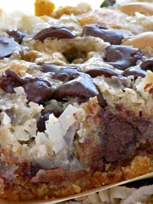 a close up of a cake on a plate with chocolate chips and coconut flakes