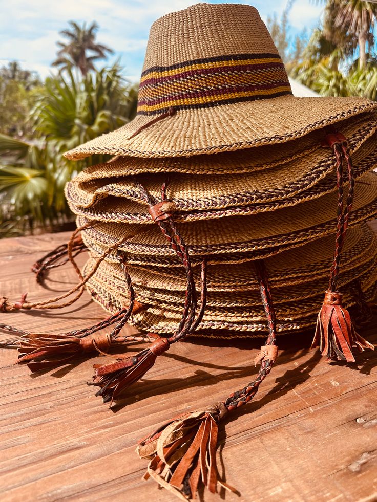 A true Island Sun Hat (Farmers Market Style) these beauties are thoughtfully handmade by talented Artisans and are intricately designed to last forever. They travel well and can be reshaped time and time again with cold water + sunlight ✨ Ideal for the beach, lake, pool or out on the boat or paddle board, these hats can easily transition with you through the seasons as they become your favorite sun hat, for any occasion. Woven from 100% South African raffia, the hat features a colorful striped p Raffia Palm, Woven Hat, Straw Sun Hat, Catalina Island, Body Balm, Straw Hats, Woven Raffia, Paddle Board, Store Front