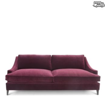 a red couch sitting on top of a white floor