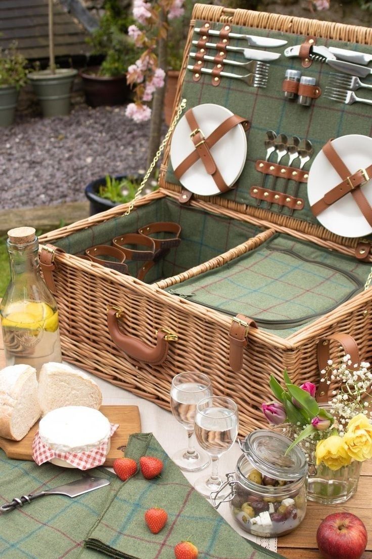 a picnic basket with utensils and plates in it