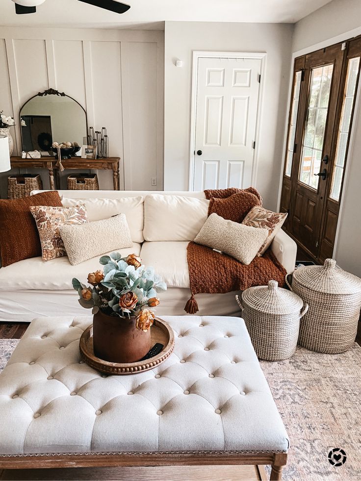 a living room filled with furniture and pillows