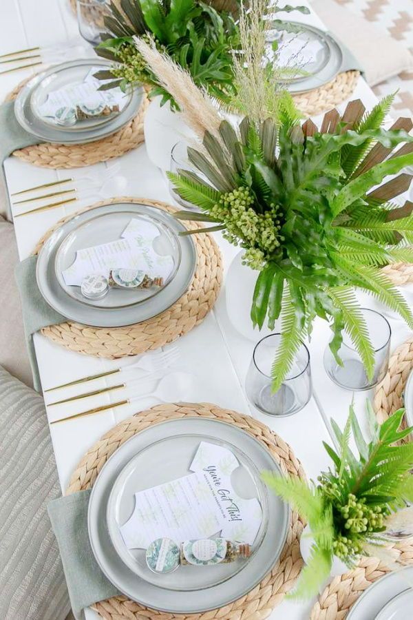 the table is set with plates and place settings