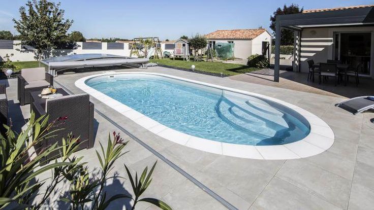 an empty swimming pool in the middle of a backyard