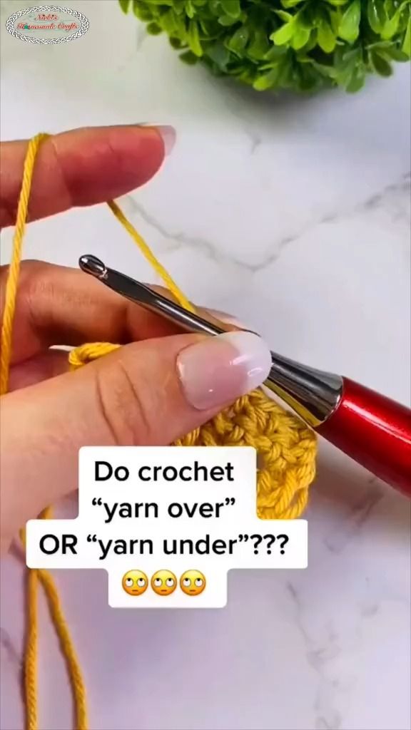 someone is crocheting the yarn with scissors