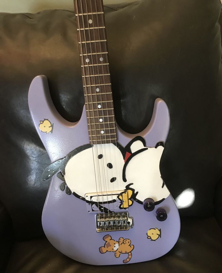 a purple guitar with a cartoon character on it