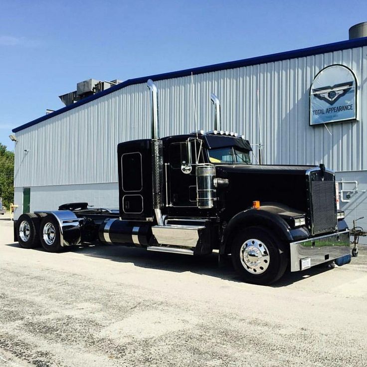 a large semi truck parked in front of a building