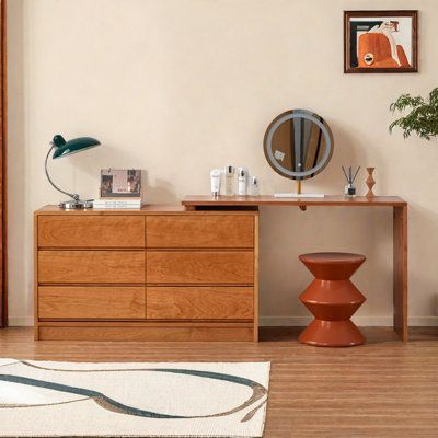 a wooden dresser sitting next to a mirror on top of a white rug in a living room