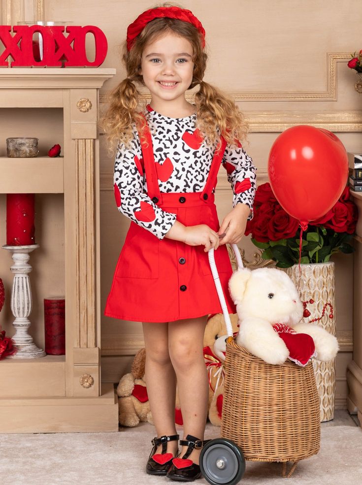 With a darling design as sweet as the little loves who don it, this festive suspender skirt set is ready for a full day of celebration. Boasting an easy slip-on fit with adjustable shoulder straps, the cute button-down design and unique animal print top make for an unbeatable outfit. Perfect for Valentine's Day, birthday parties, and year-round play Soft fabric blend is gentle on her skin and allows for stretch & holiday play The set features an animal print top with hearts and a red overall ski Plaid Overall Dress, Matching Costumes, Overall Skirt, Chic Pattern, Suspender Skirt, Valentines Outfits, Girls Valentines, Halloween Girl, Overall Dress