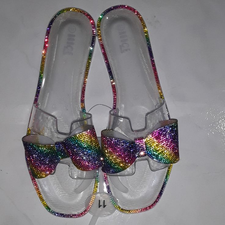 Multicolored Rhinestone Jelly Slippers. Clear In Color. Rainbow Round Toe Sandals For Party, Rainbow Sandals With Round Toe For Party, Multicolor Flat Sandals For Parties, Multicolor Flat Synthetic Jelly Sandals, Multicolor Rhinestone Sandals For Spring, Multicolor Rhinestone Sandals For Summer, Glitter Round Toe Jelly Sandals For Party, Summer Multicolor Sandals With Rhinestones, Multicolor Rhinestone Beach Sandals