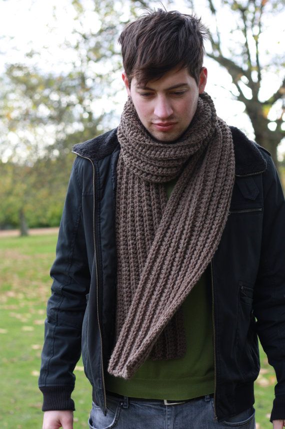 a young man wearing a scarf and jacket