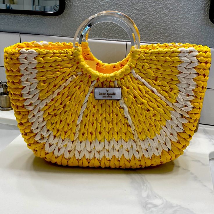 Beautiful Kate Spade Lemon Medium Tote. New With Tags Never Used. Original Price $399 Tote With Open Top Closure And Two Clear Plastic Circular Handles. Two Interior Zipper Pockets And Leather Patch Logo On Front. 12.59"W X 7.87"H X 3.3"D Dual Handle Drop: 4" Style: Wkru6835 Color: Yellow Multi (772) Yellow Shopping Bag For Beach Season, Yellow Shopping Bags For Beach Season, Yellow Bags For Shopping In Beach Season, Yellow Beach Bags With Braided Handles, Chic Yellow Straw Bag For Everyday Use, Yellow Bags With Braided Handles For Beach Season, Chic Yellow Straw Bag For Everyday, Yellow Straw Tote Bag For Spring, Yellow Tote Straw Bag For Spring